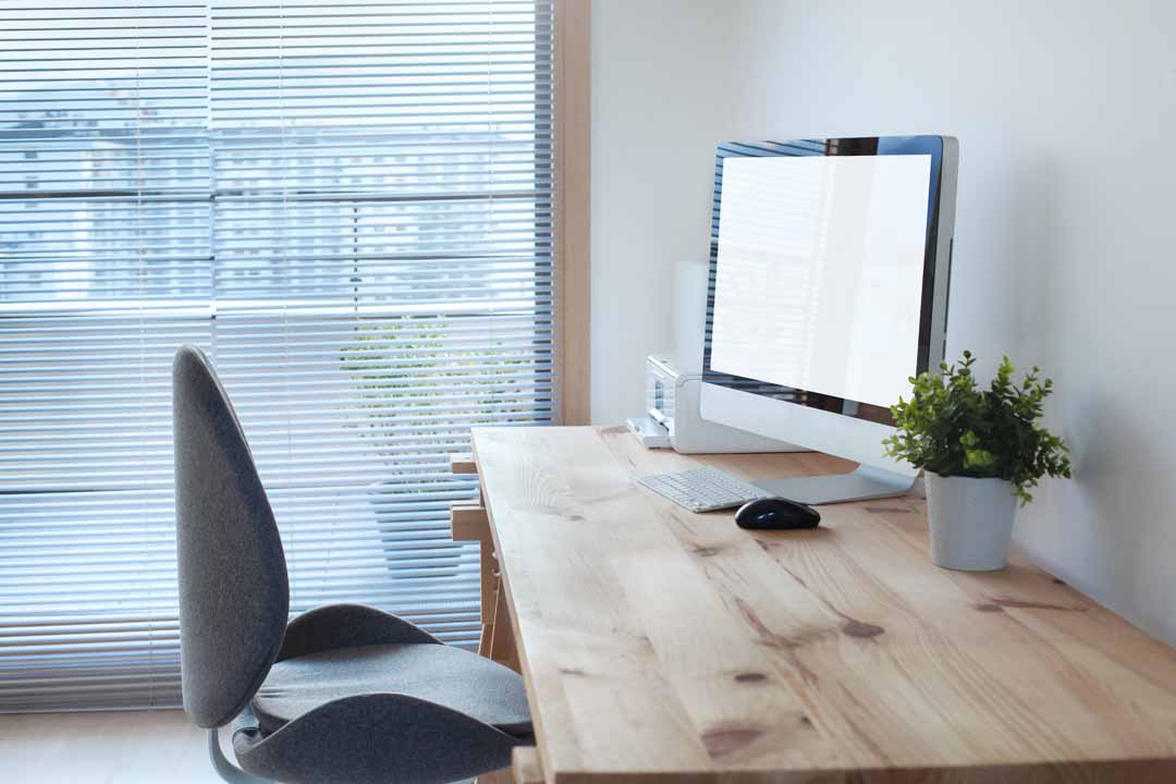 workspace interior with computer on wooden table and office chair